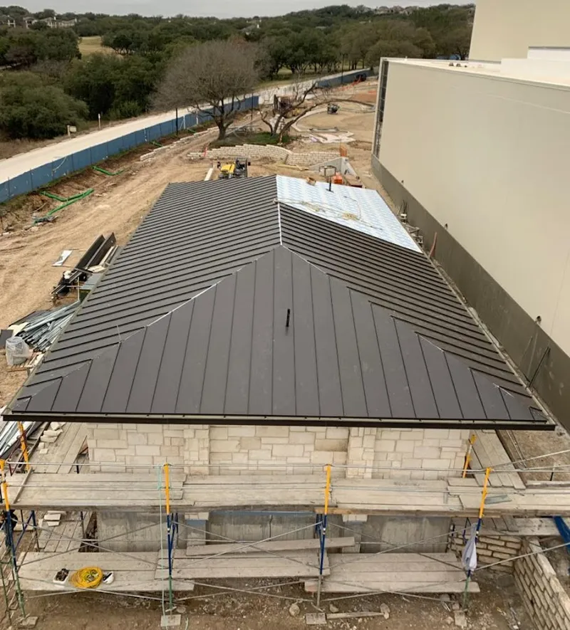 Metal roof new construction with scaffolding in Bemiss