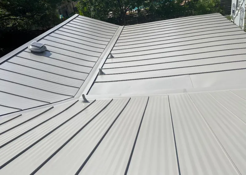 Solar attic fan installed on a metal roof for Roof Ventilation in Bemiss